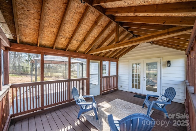 sunroom / solarium featuring lofted ceiling and french doors