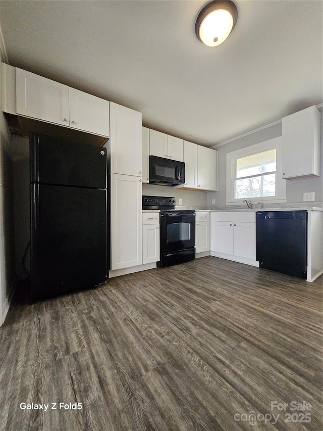 kitchen featuring black appliances, dark wood-style flooring, light countertops, and white cabinetry