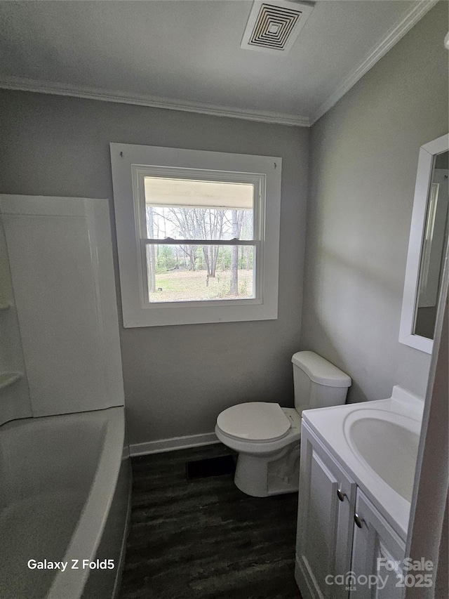 full bath featuring a tub to relax in, visible vents, toilet, vanity, and wood finished floors