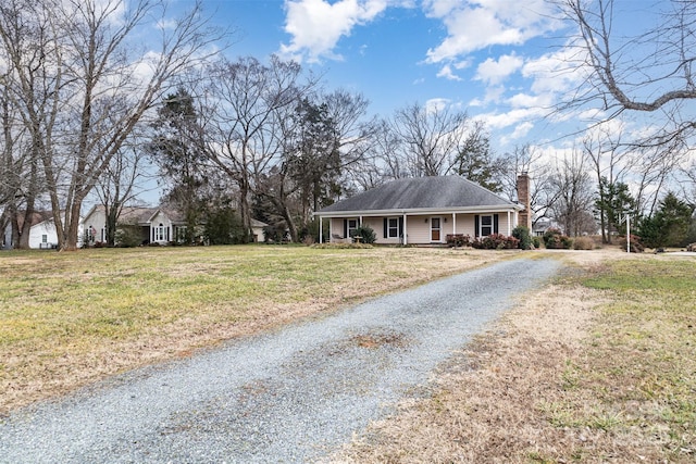 ranch-style house with covered porch and a front yard