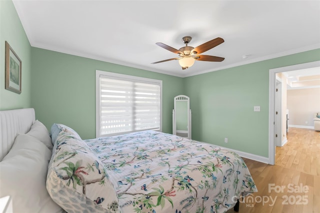 bedroom featuring crown molding, ceiling fan, and light hardwood / wood-style flooring