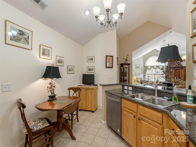 kitchen with vaulted ceiling, dishwasher, sink, dark stone countertops, and hanging light fixtures