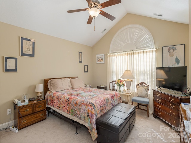 bedroom with ceiling fan, lofted ceiling, and light carpet