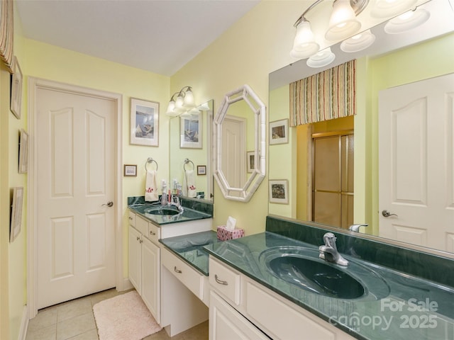 bathroom featuring tile patterned floors, an enclosed shower, and vanity