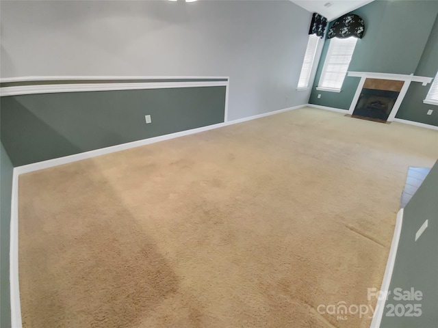 unfurnished living room with lofted ceiling and carpet