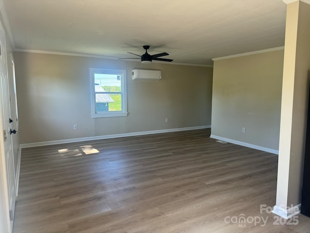 empty room with dark hardwood / wood-style flooring, a wall unit AC, ornamental molding, and ceiling fan