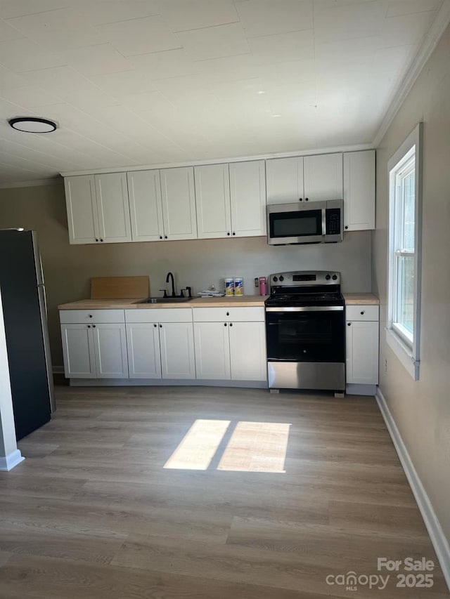 kitchen featuring white cabinetry, sink, and stainless steel appliances