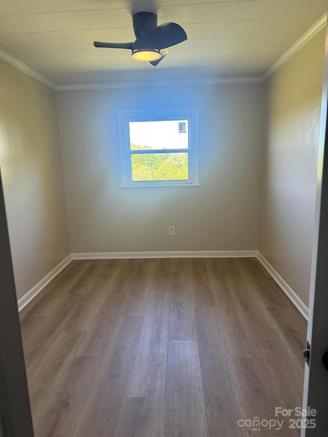 spare room with crown molding, ceiling fan, and hardwood / wood-style flooring