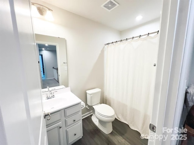 bathroom featuring hardwood / wood-style flooring, vanity, and toilet