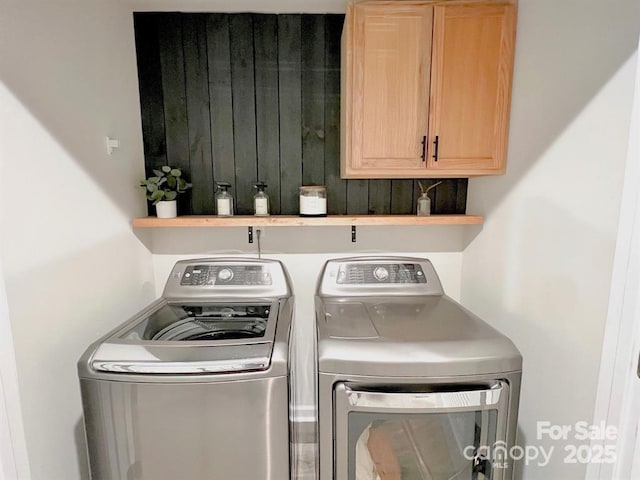 laundry room featuring independent washer and dryer and cabinets