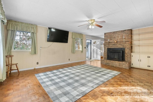 unfurnished living room with ceiling fan, light parquet flooring, and a fireplace