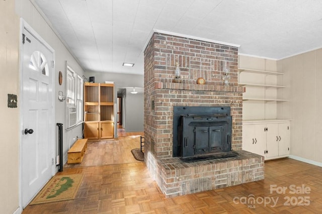 living room featuring a brick fireplace and light parquet flooring