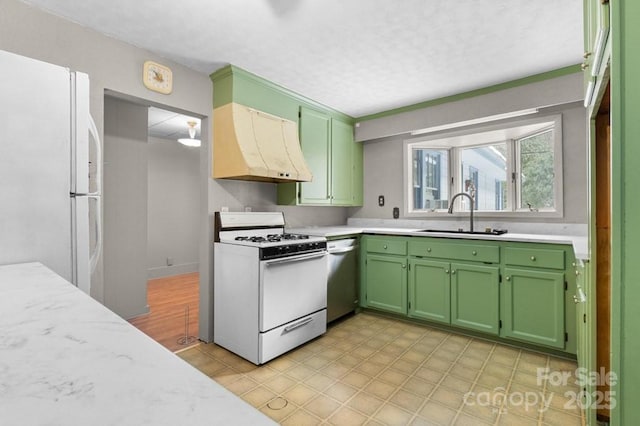 kitchen featuring premium range hood, sink, white appliances, and green cabinetry