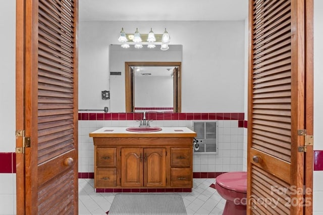 bathroom with tile walls, vanity, tile patterned flooring, and heating unit