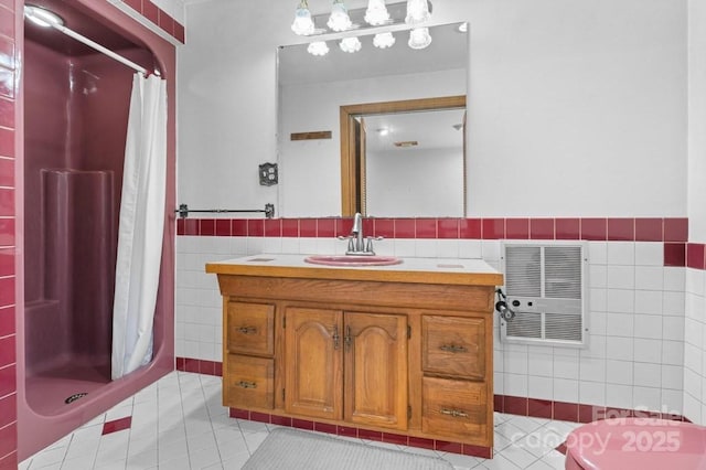 bathroom featuring walk in shower, heating unit, tile walls, vanity, and tile patterned flooring