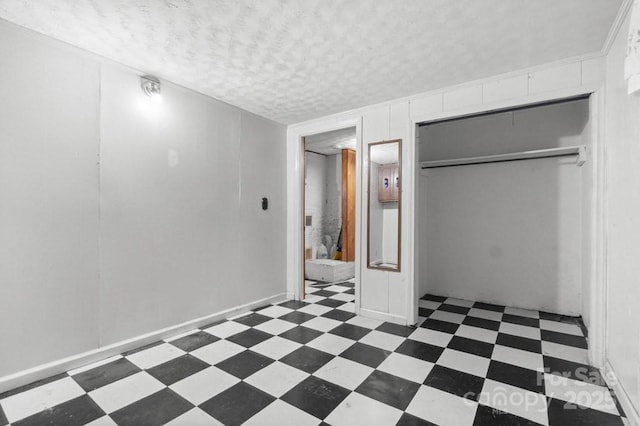 unfurnished bedroom with a closet and a textured ceiling