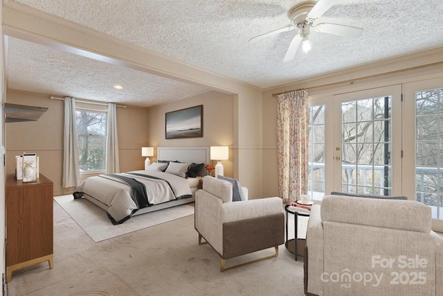 carpeted bedroom featuring a textured ceiling, access to exterior, and ceiling fan