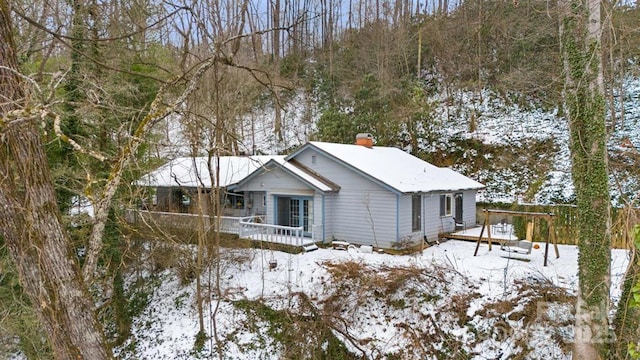 view of snowy exterior with a deck