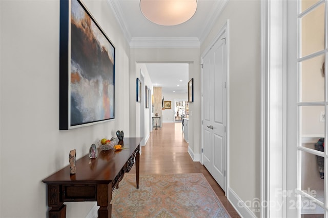 corridor featuring crown molding and light wood-type flooring