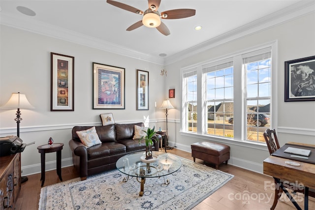 living room featuring crown molding, ceiling fan, plenty of natural light, and hardwood / wood-style floors