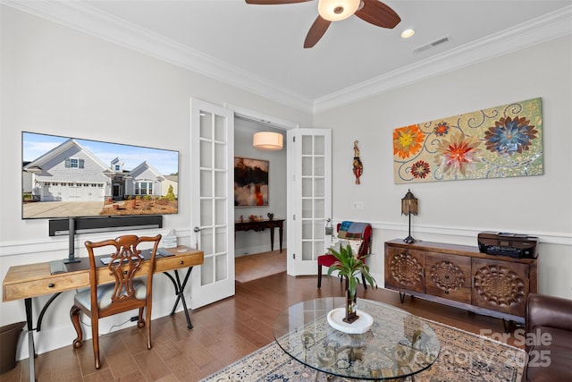 living area with crown molding, dark hardwood / wood-style floors, ceiling fan, and french doors