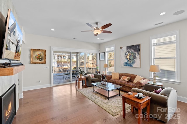 living room featuring wood-type flooring and ceiling fan