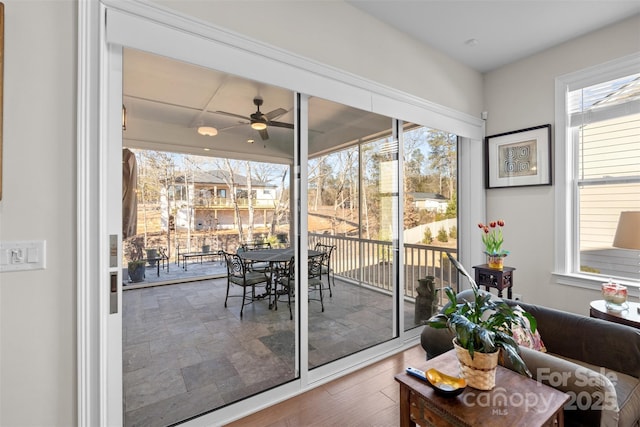 sunroom / solarium featuring ceiling fan