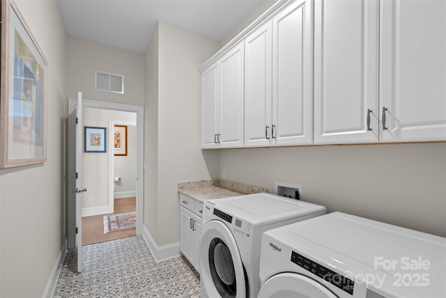 laundry area with cabinets and separate washer and dryer