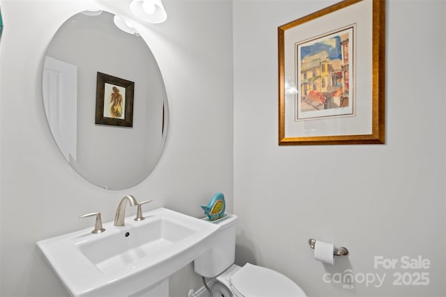 bathroom featuring sink and toilet