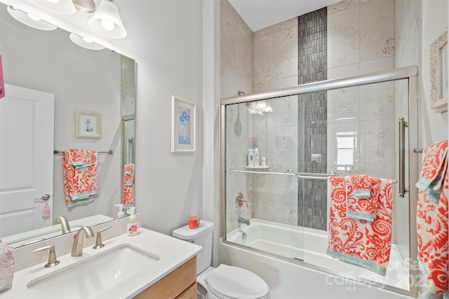 full bathroom featuring toilet, vanity, and bath / shower combo with glass door