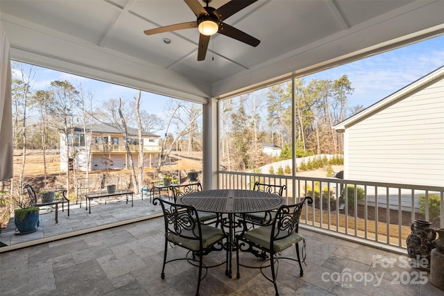 sunroom / solarium featuring ceiling fan