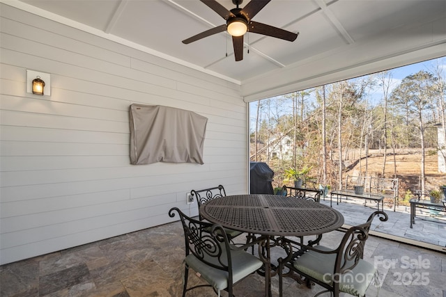 sunroom featuring ceiling fan and a healthy amount of sunlight