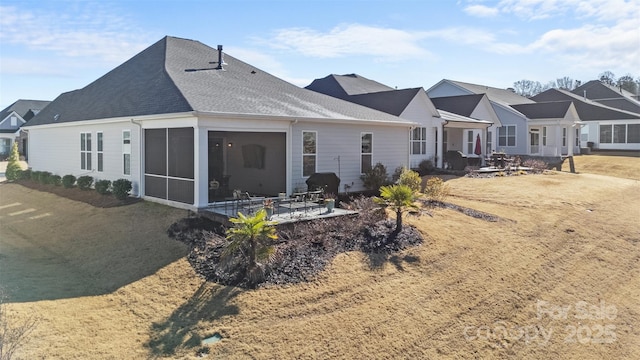 rear view of property featuring a patio area