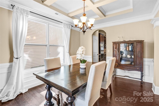 dining room with a chandelier, dark hardwood / wood-style flooring, coffered ceiling, crown molding, and beam ceiling