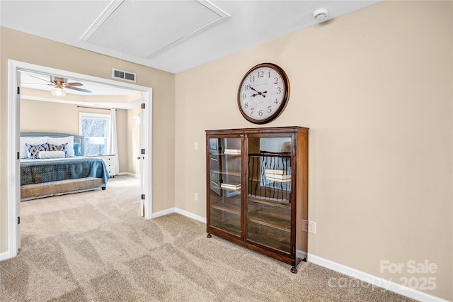 hall with light colored carpet