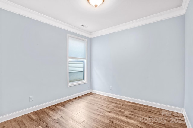 unfurnished room featuring crown molding and light hardwood / wood-style floors