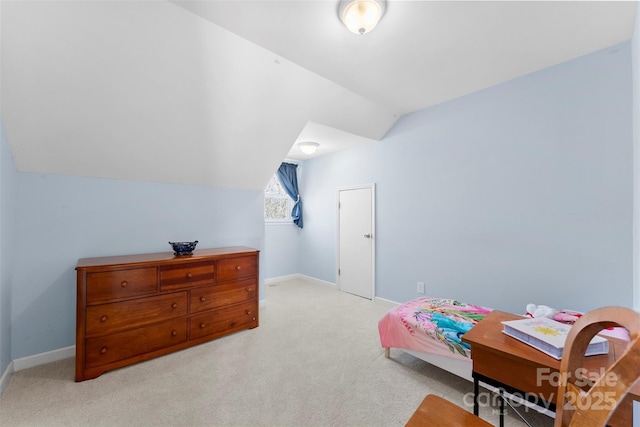 bedroom with vaulted ceiling and light carpet