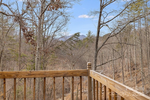 wooden terrace with a wooded view