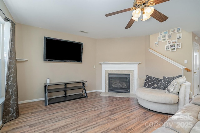 living room featuring hardwood / wood-style floors and ceiling fan