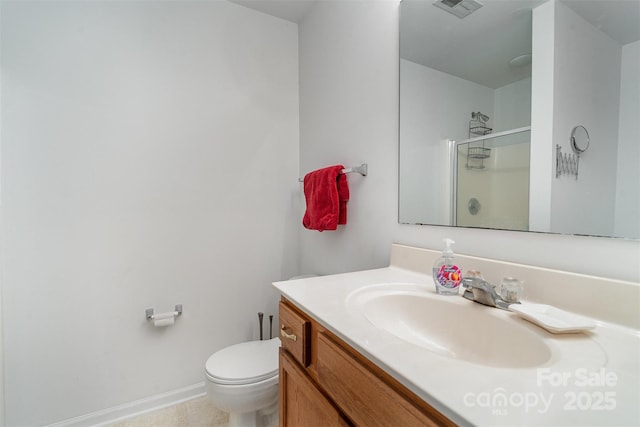 bathroom with an enclosed shower, vanity, and toilet