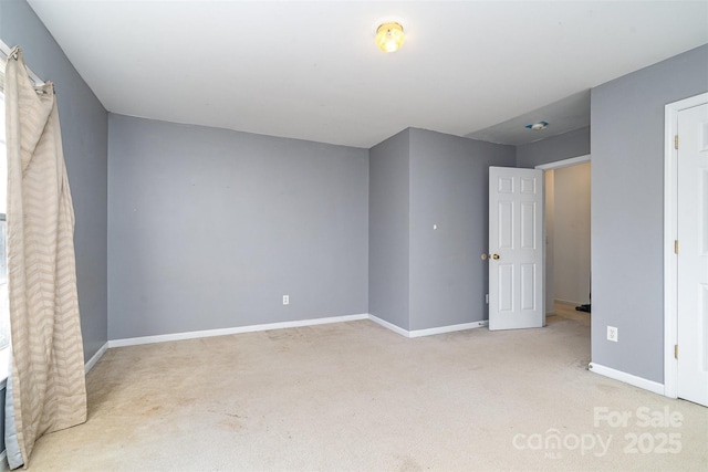 unfurnished bedroom featuring light carpet