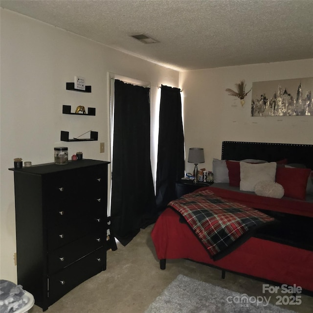 carpeted bedroom featuring a textured ceiling