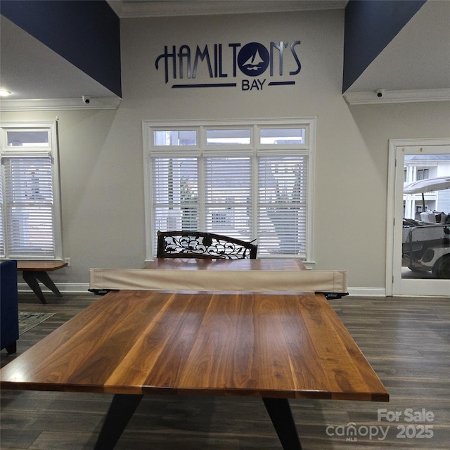 unfurnished dining area featuring ornamental molding and dark hardwood / wood-style floors