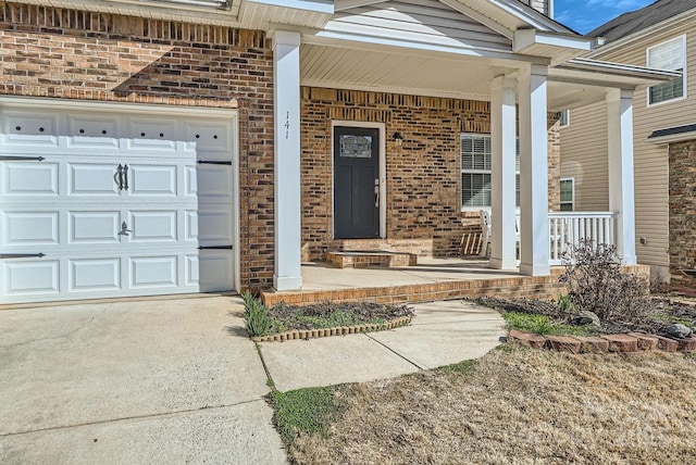 property entrance with a garage and covered porch