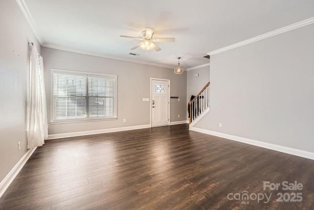 foyer with crown molding, dark wood-type flooring, and ceiling fan