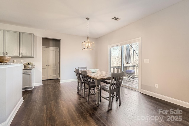 dining room featuring dark hardwood / wood-style floors and a notable chandelier