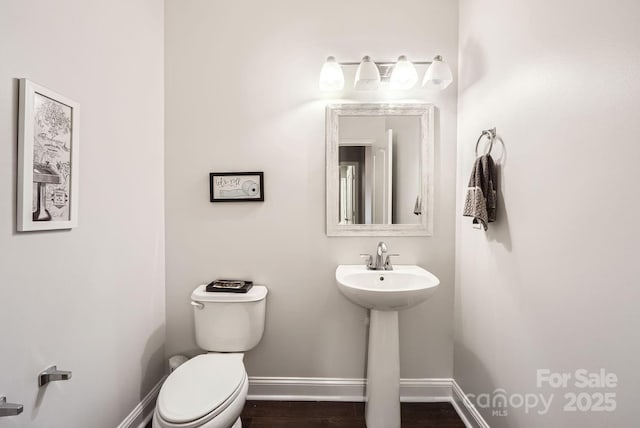 bathroom with sink, hardwood / wood-style floors, and toilet