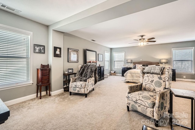 carpeted bedroom featuring ceiling fan and multiple windows