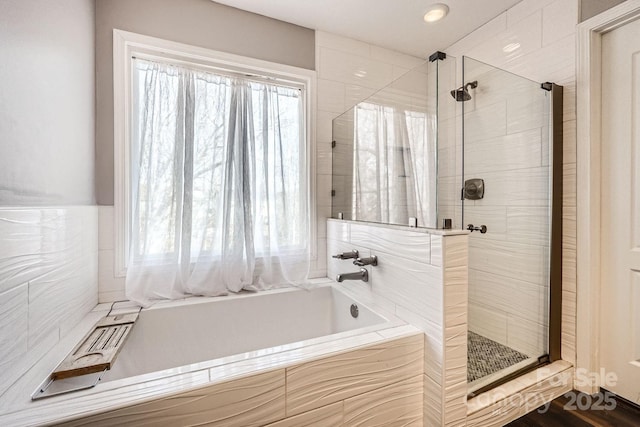 bathroom featuring plus walk in shower and a wealth of natural light