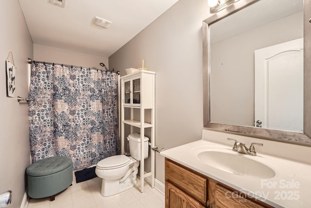 bathroom with vanity, tile patterned flooring, and toilet